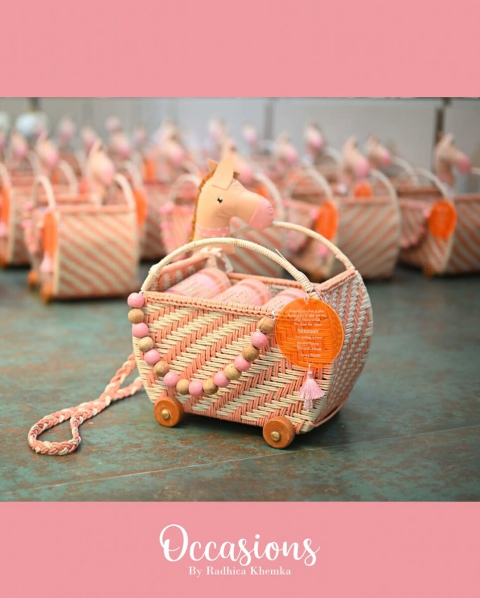 Rolling in with charm and detail! From handcrafted cradles to felt horse heads, pink-beige bead buntings, and a tassel-kissed acrylic tag—this baby girl announcement is made to steal hearts.
